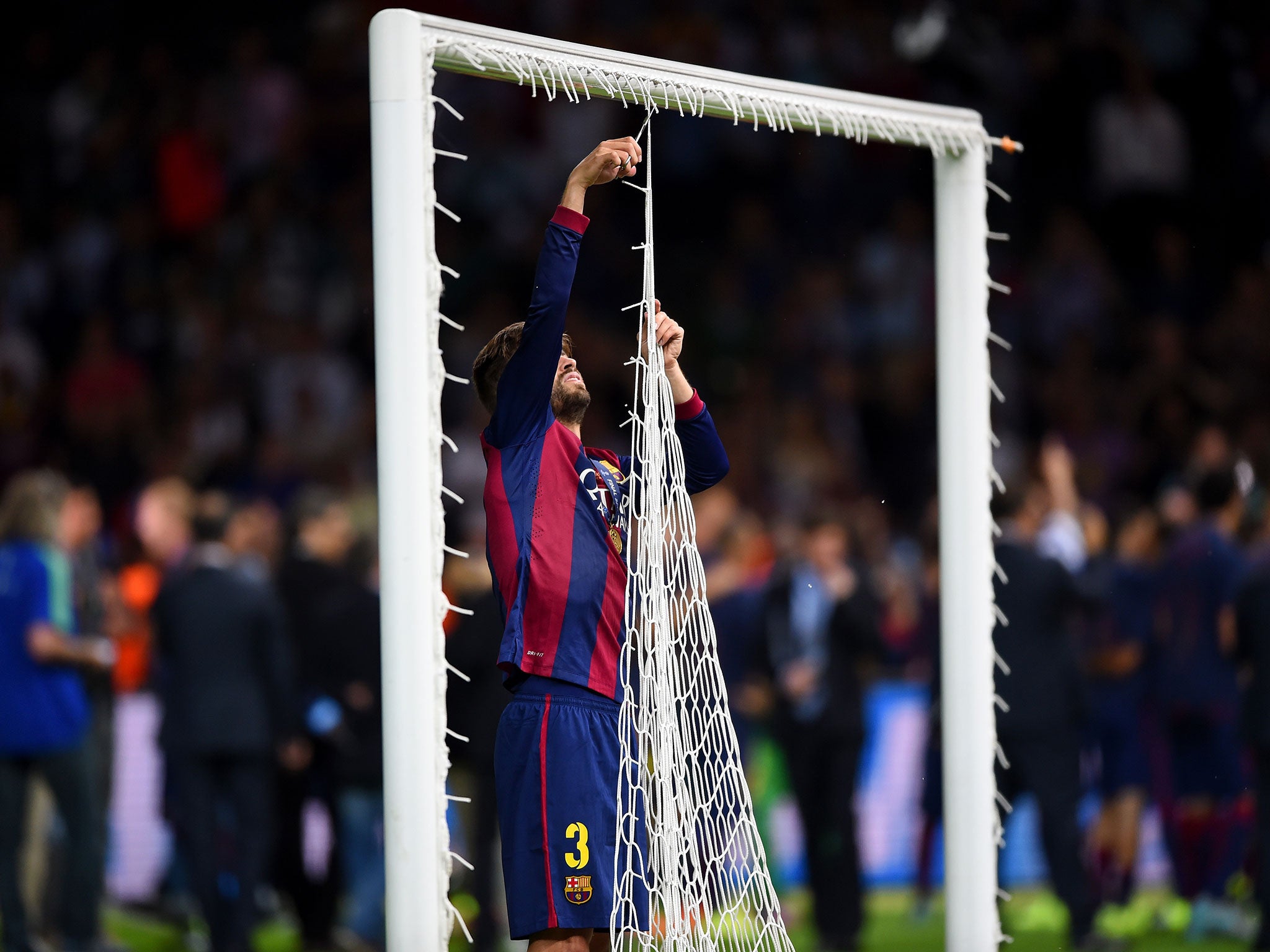Gerard Pique cuts down the goal net after the Champions League final win over Juventus