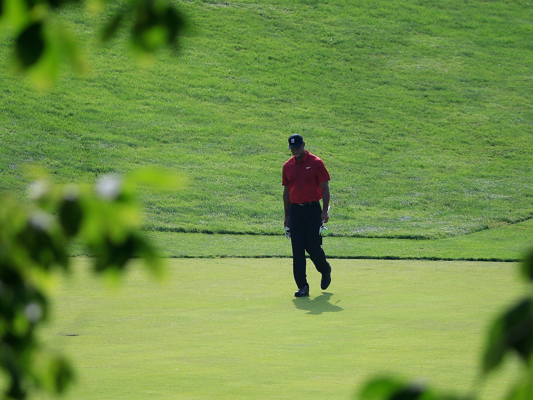 A dejected Woods makes his way around the course