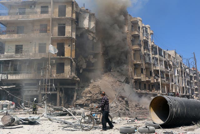 A man walks past the rubble of a building following reported shelling by Syrian government forces in the Bab al-Hadid neighbourhood of the northern city of Aleppo 