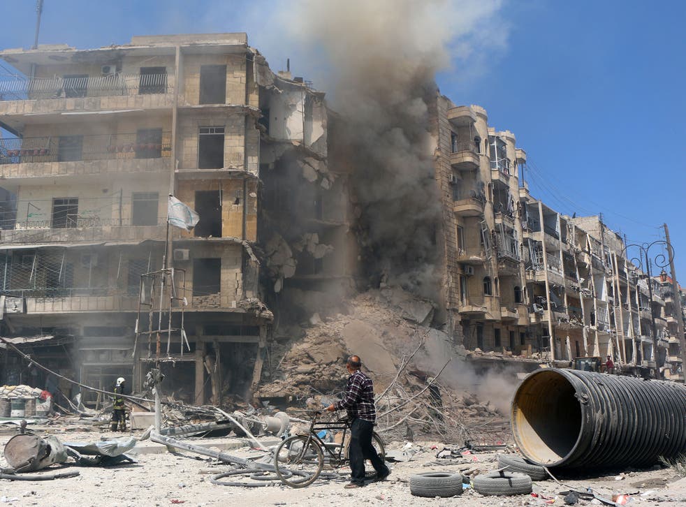 A man walks past the rubble of a building following reported shelling by Syrian government forces in the Bab al-Hadid neighbourhood of the northern city of Aleppo 
