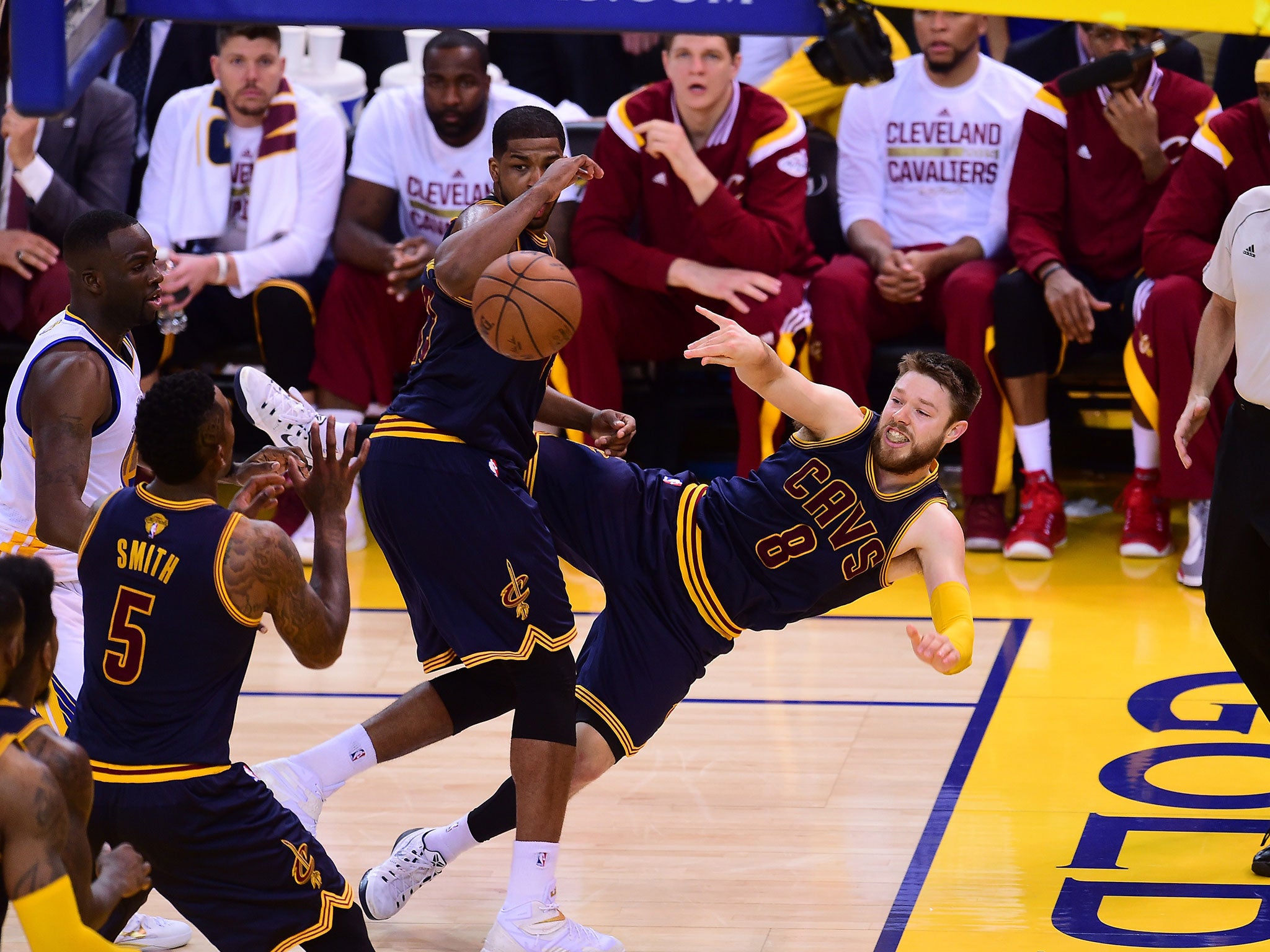 Matthew Dellavedova #8 of the Cleveland Cavaliers passes around Tristan Thompson #13 during Game Two