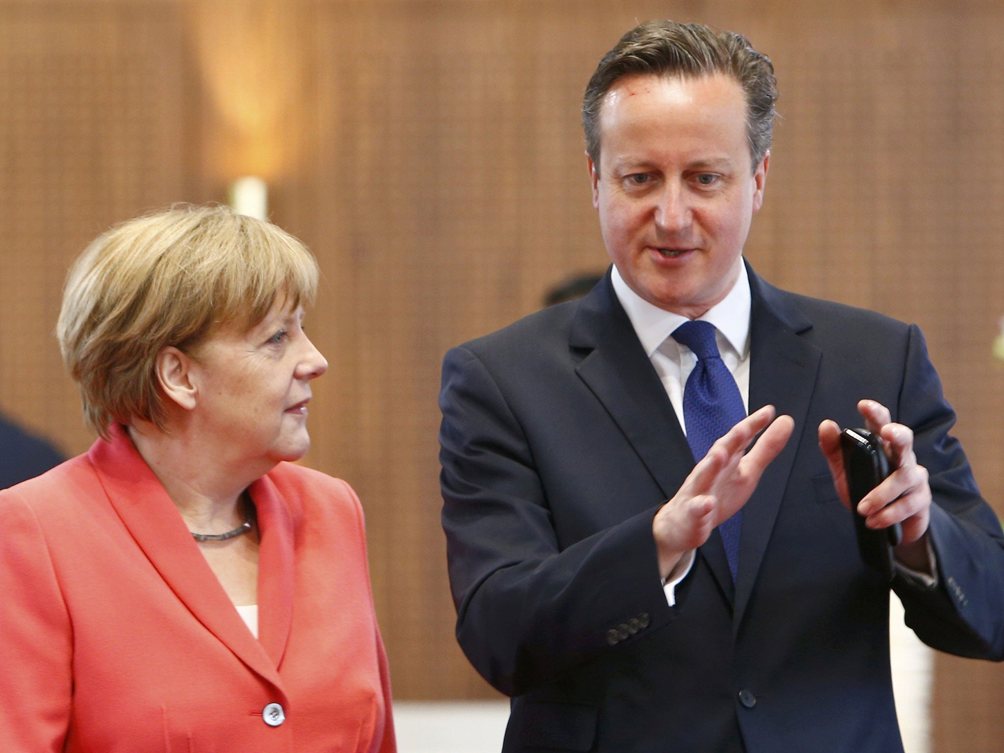 Angela Merkel chats with British Prime Minister David Cameron prior to a working meeting at the G7 summit in Germany on June 8, 2015