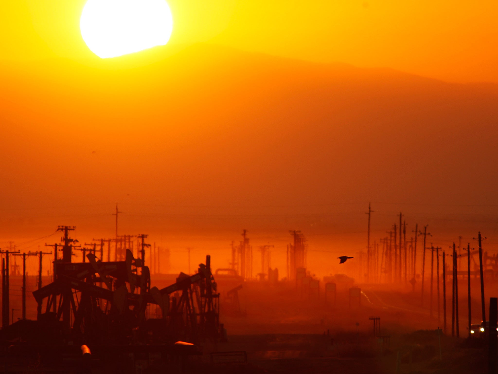 The sun rises over an oil field over the Monterey Shale formation where gas and oil extraction using hydraulic fracturing, or fracking, is on the verge of a boom on March 24, 2014 near Lost Hills, California
