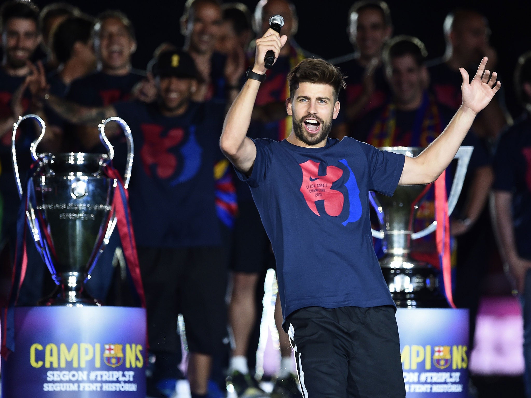 Gerard Pique celebrates Barcelona's treble success