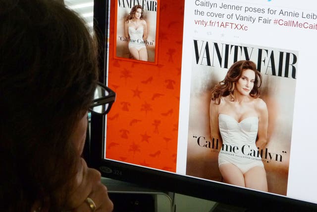 A journalist looks at Vanity Fair's Twitter site with the Tweet about Caitlyn Jenner