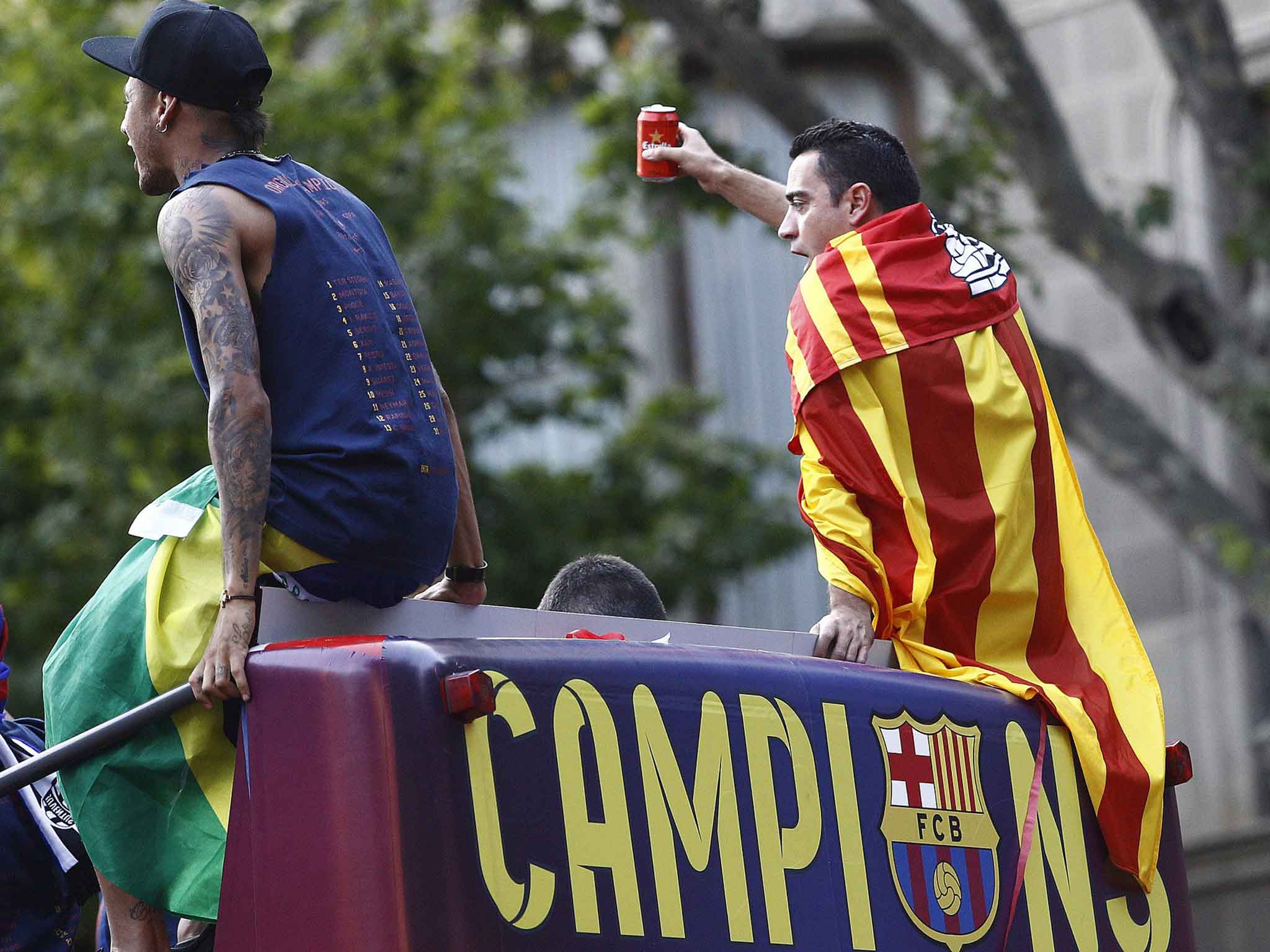 Neymar and Xavi during the Barcelona bus parade