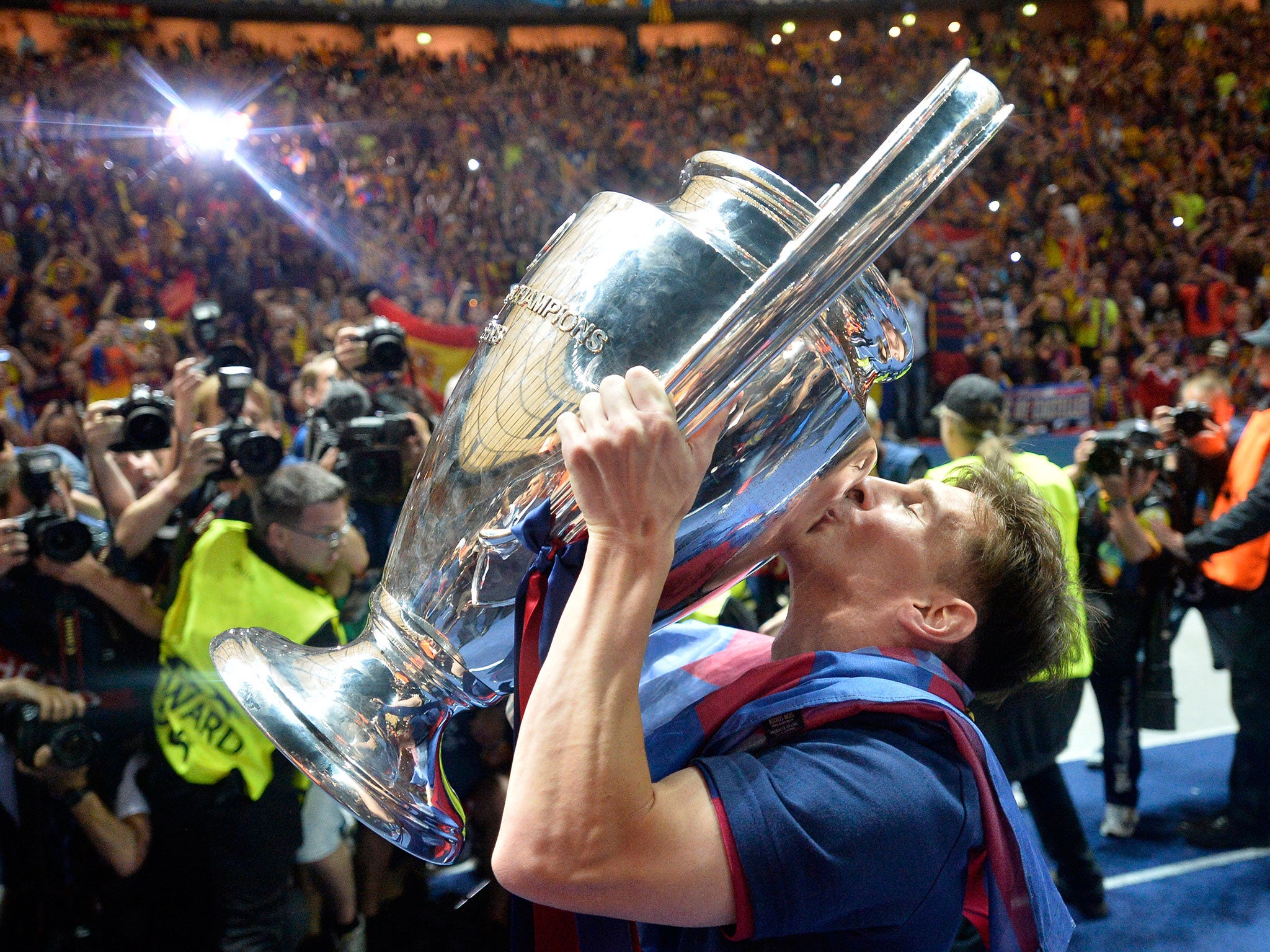 Barcelona's Lionel Messi kisses the trophy after his team won 3-1 the Champions League final soccer match between Juventus Turin and FC Barcelona at the Olympic stadium in Berlin