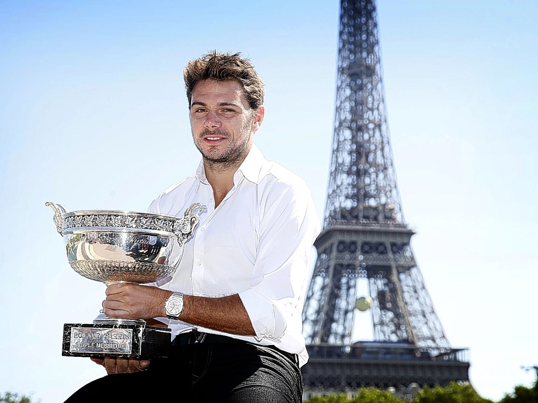 Stan Wawrinka holds La Coupe des Mousquetaires trophy in front of the Eiffel Tower after his dramatic four set win over Novak Djokovic in the French Open men’s singles final