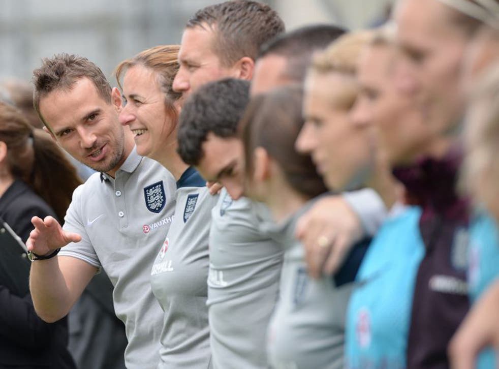 Mark Sampson shares a joke with his England team in training ahead of the World Cup