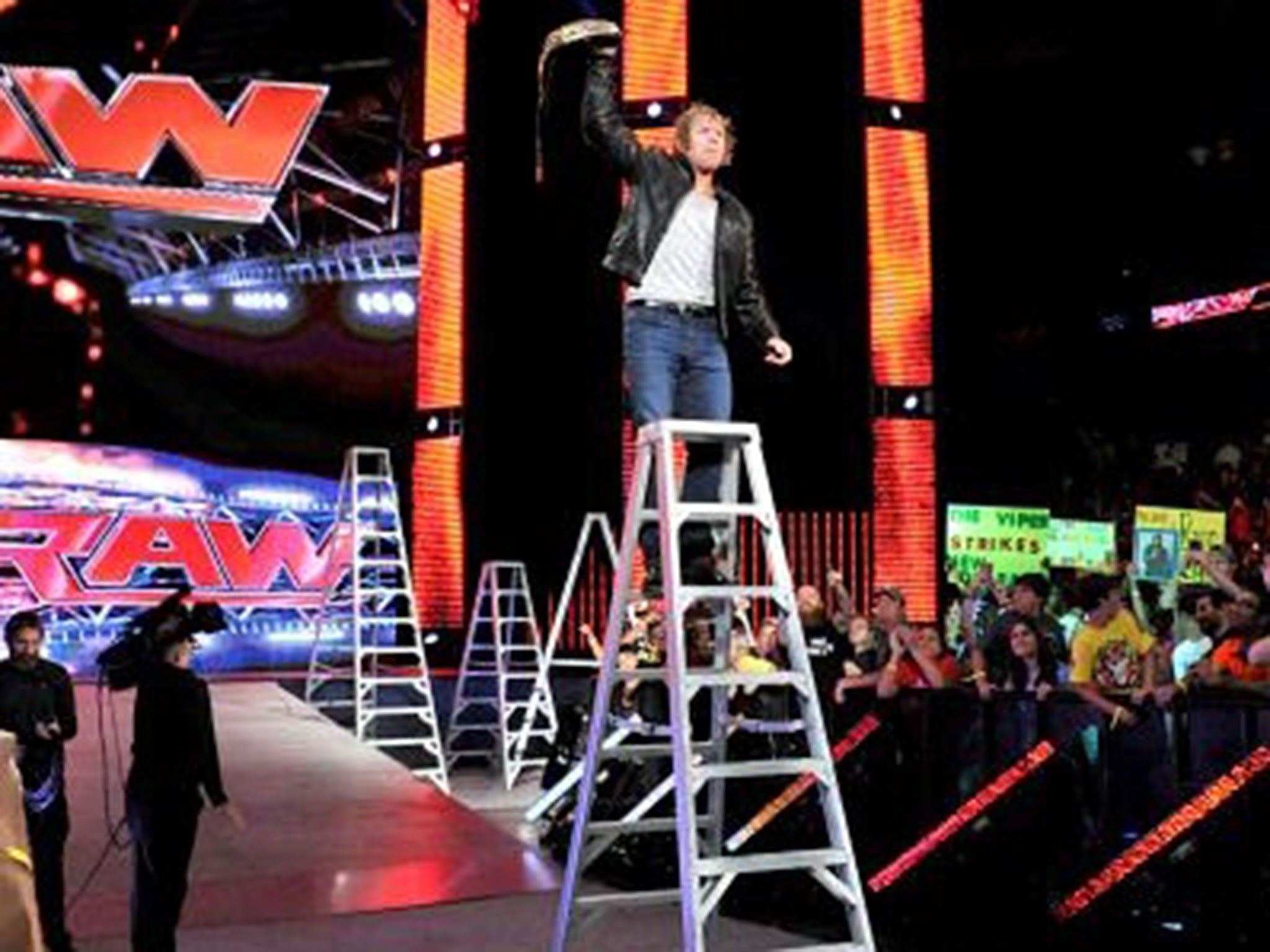 Dean Ambrose lifts Seth Rollins' WWE title belt