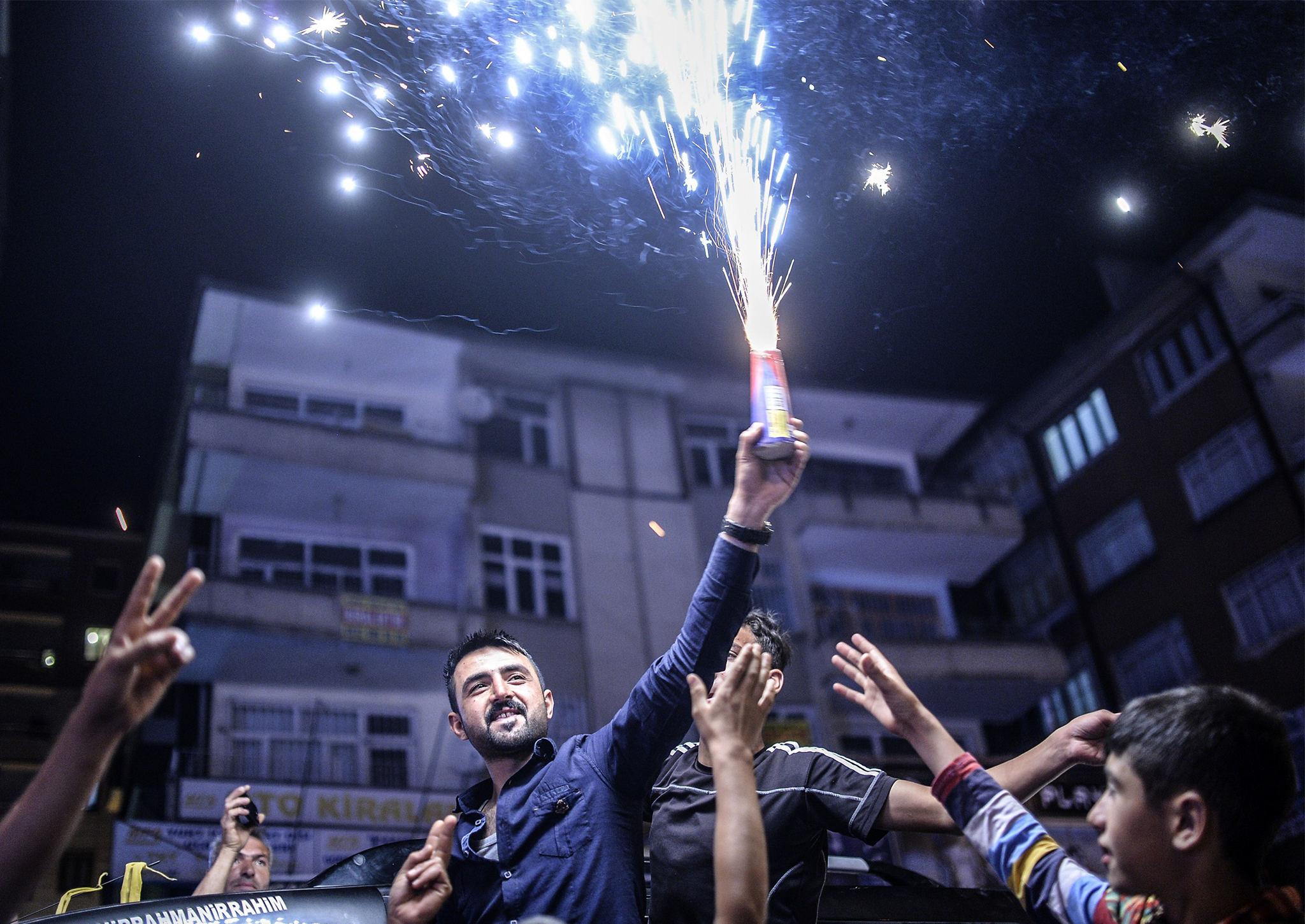 Young supporters of pro-Kurdish Peoples' Democratic Party (HDP) celebrate in the streets the results of the legislative election