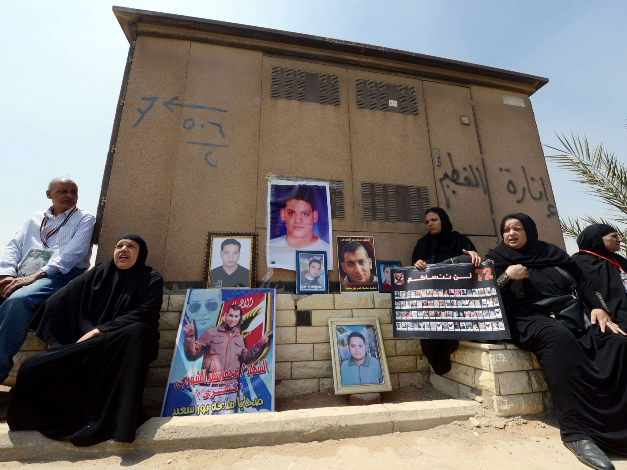 Egyptian families of the victims of a February 2012 riot in the eastern city of Port Said gather outside a court in Cairo as they wait for the final verdict in the retrial of football fans over the riot that cost the lives of 74 people.
