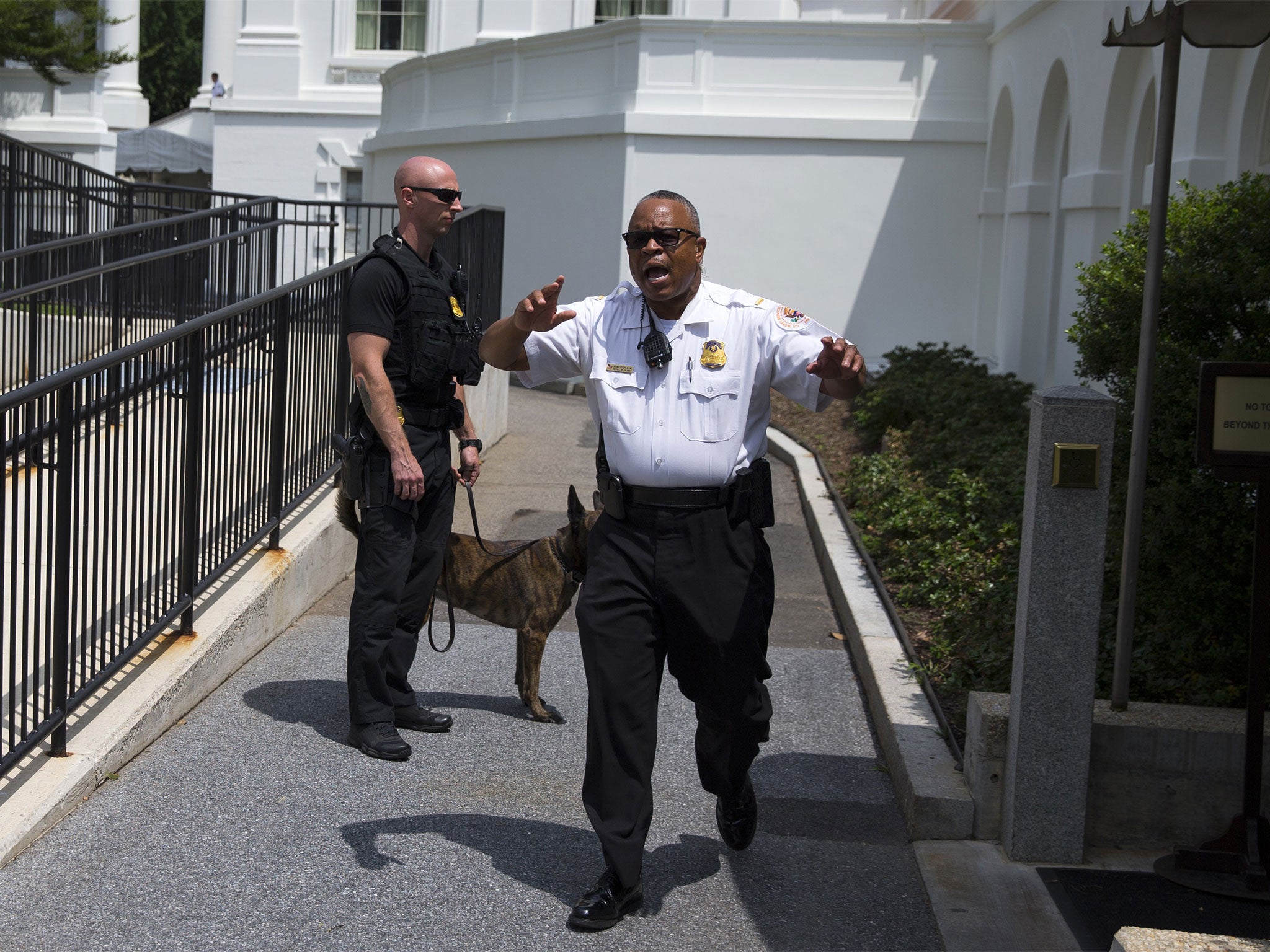 Secret Service police move members of the media outside the briefing room