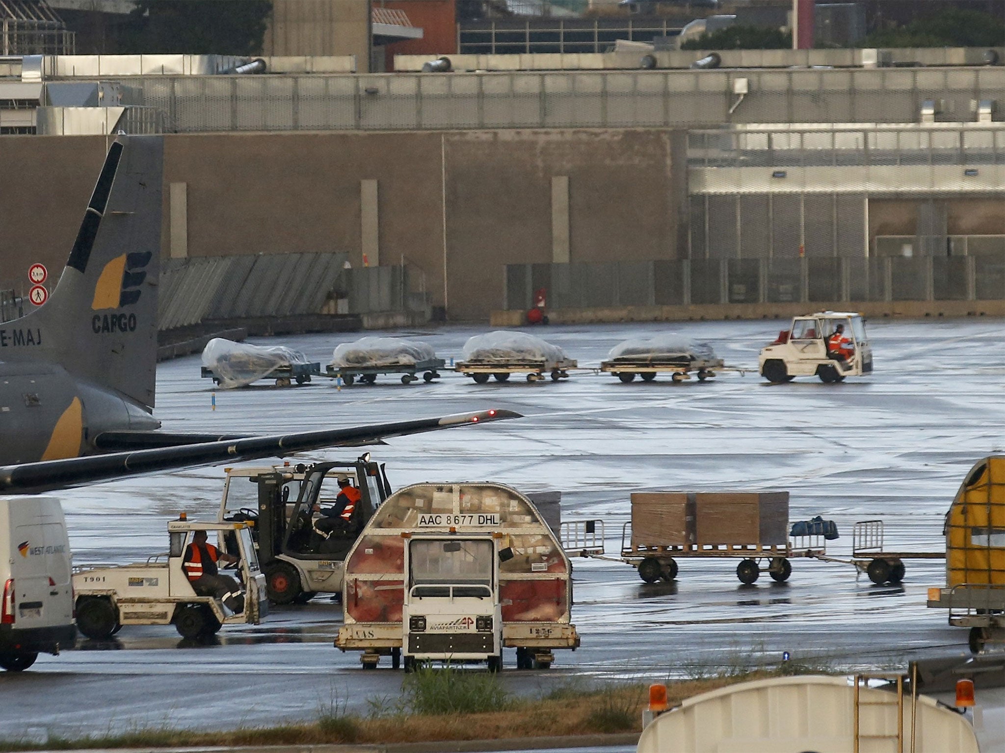 Coffins are loaded on to the plane at Marseille Provence Airport