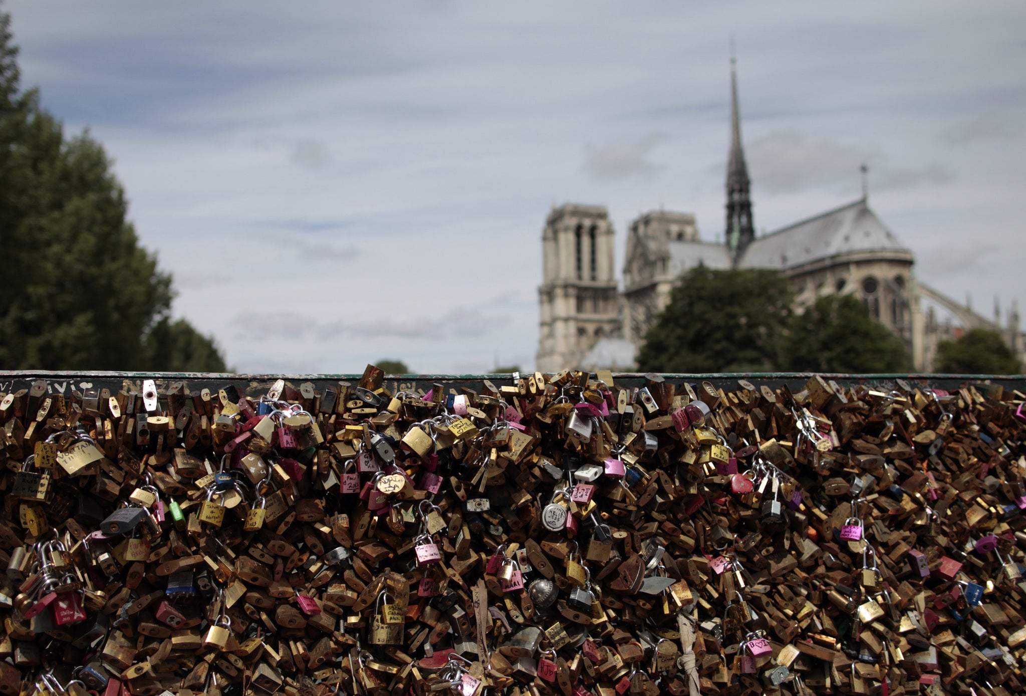 The love padlocks, which had been a romantic ritual for many couples visiting the French capital, will now be sold with proceeds going to refugees in the city