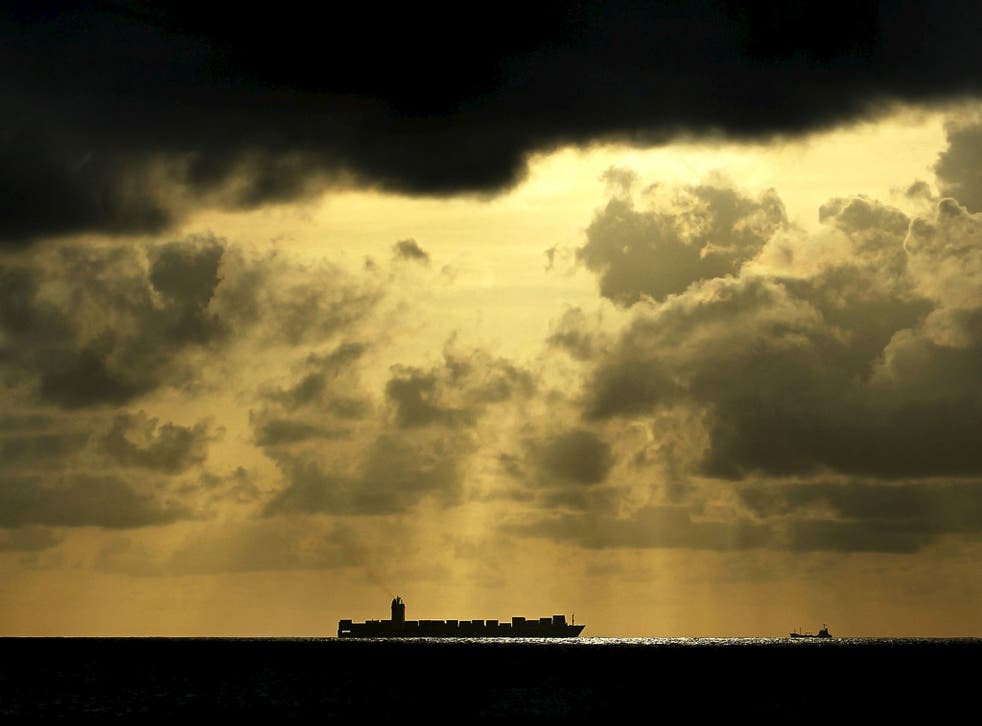 A container ship sails towards Colombo Harbour as the sun sets in Colombo, Sri Lanka