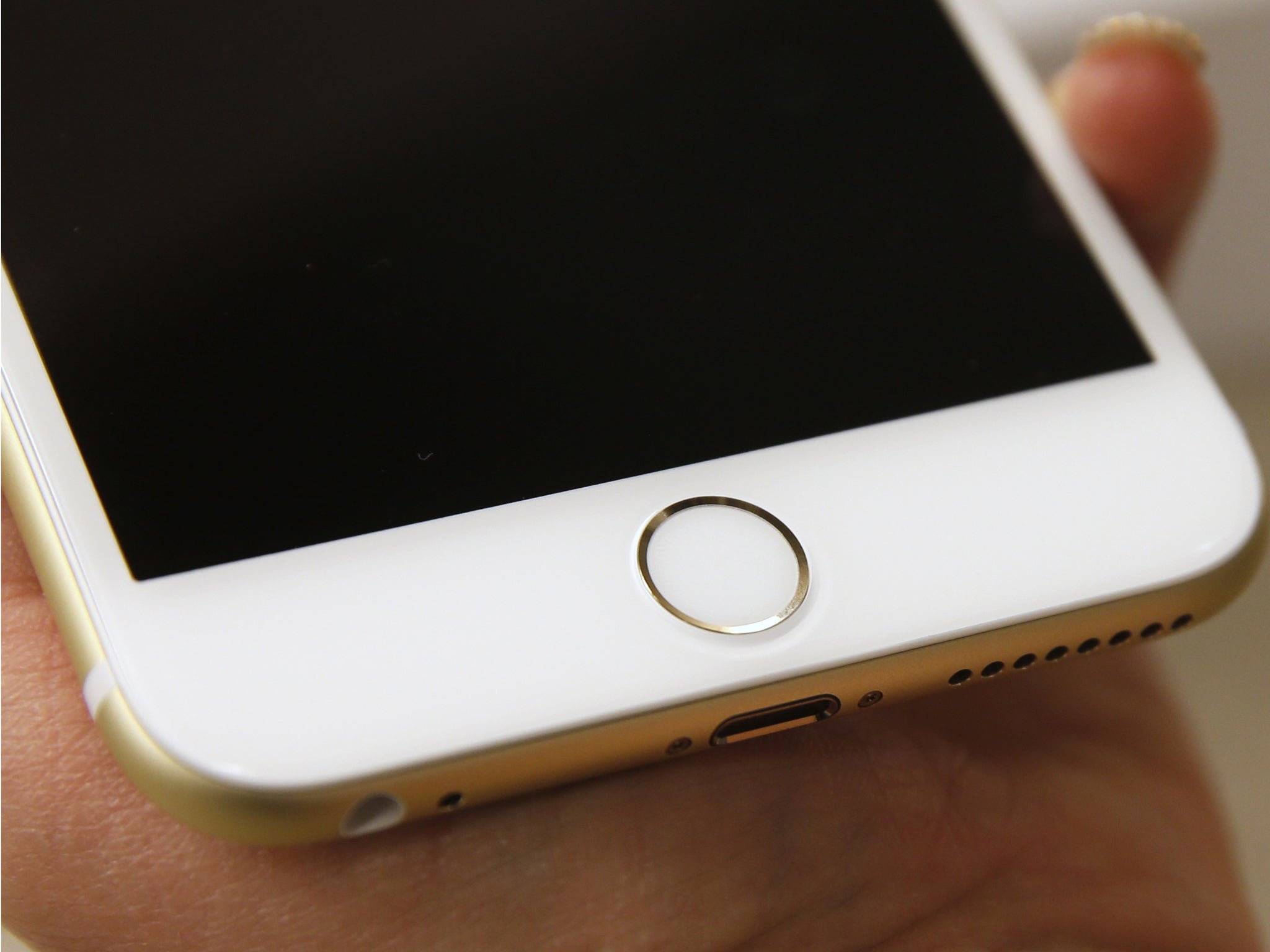 The Touch ID of an Apple iPhone 6 Plus gold