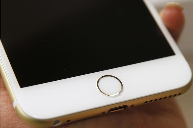 The Touch ID of an Apple iPhone 6 Plus gold