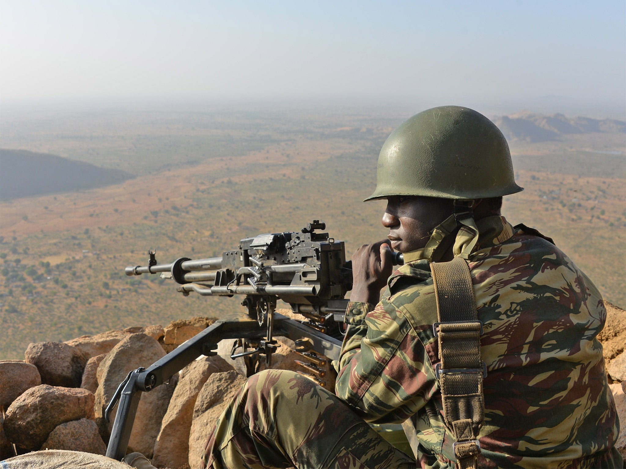 A soldier defends the village of Mabass, in the north of Cameroon, from Boko Haram fighters. The extremist group has killed almost 100 people in Kukawa.