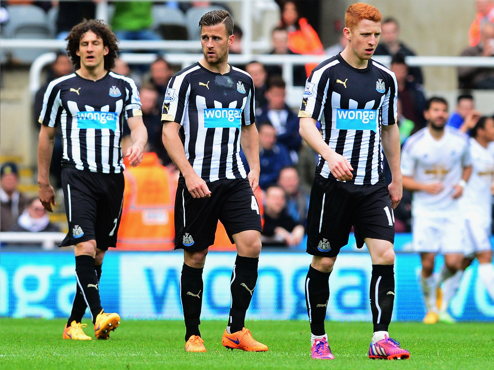 Newcastle players Fabricio Coloccini, Ryan Taylor and Jack Colback look glum during their defeat to Swansea in April