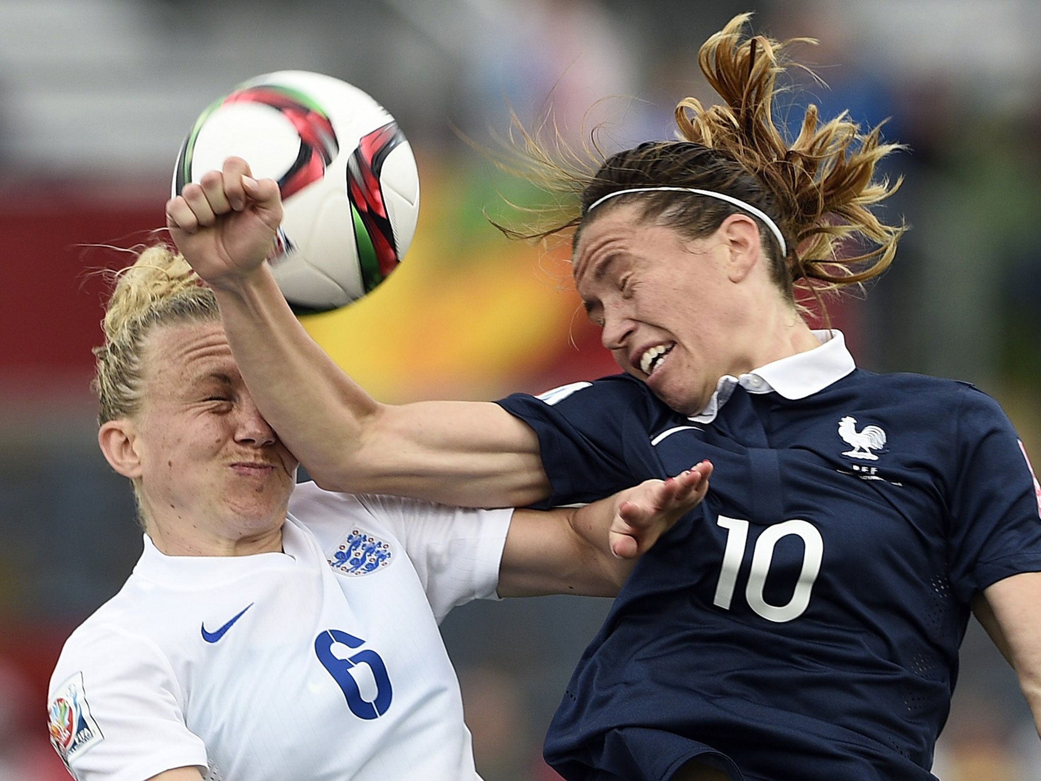 Laura Bassett is elbowed in the face by France's Camille Abily