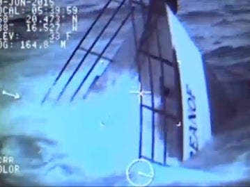 Dramatic still of an Alaskan fishing ship sinking; fishermen rescued by U.S. Coast Guard