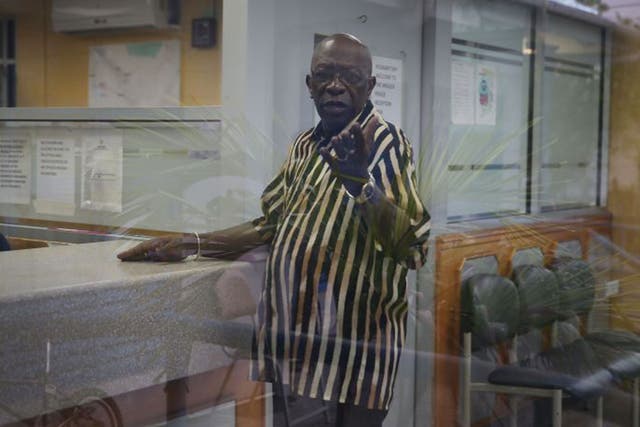 Former Fifa vice-president Jack Warner reacts to being photographed as he waits to sign in at the front desk of the Arouca Police Station as required under his bail agreement on June 11, 2015 in Arouca, Trinidad And Tobago.
