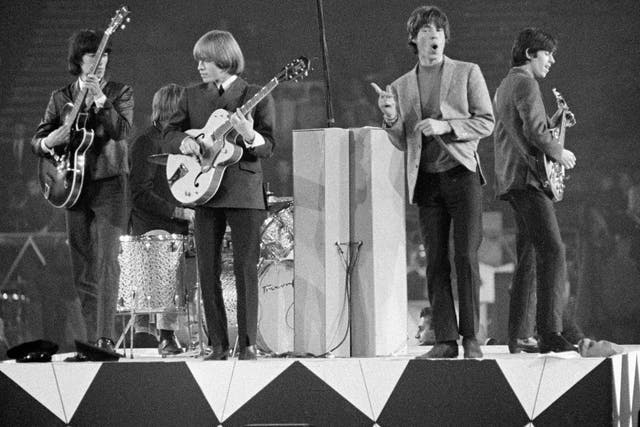 The Rolling Stones performing in concert in 1964