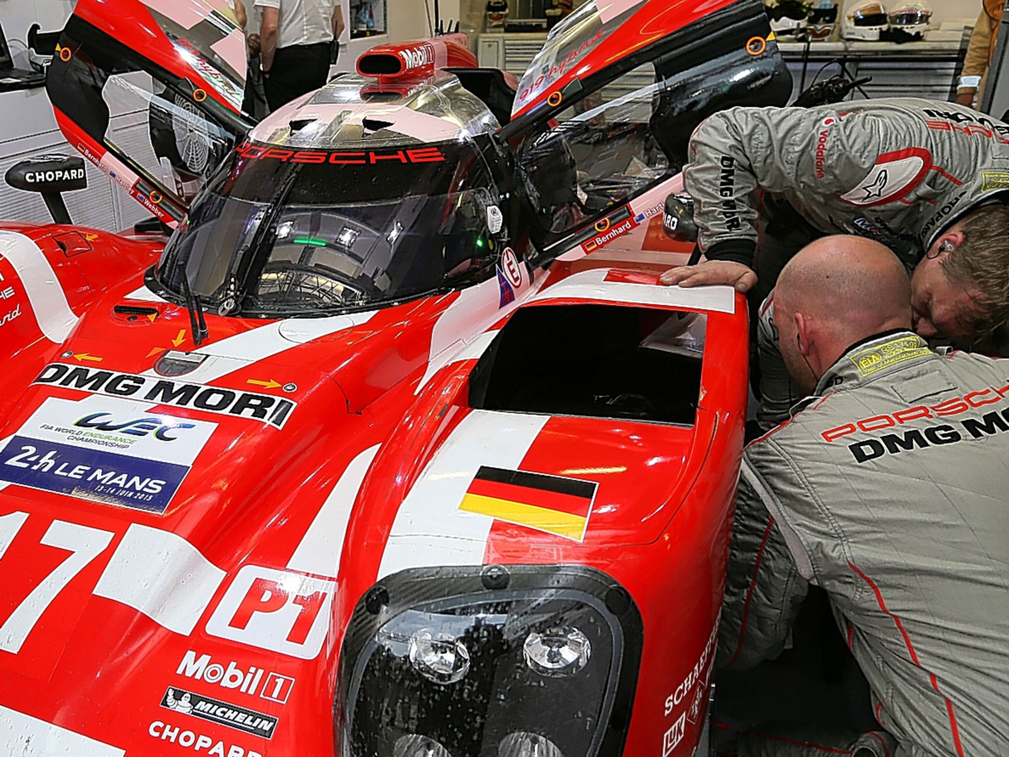Mechanics work on the Porsche 919 Hybrid No 17, which will be driven by Mark Webber, ahead of the Le Mans 24-hour race