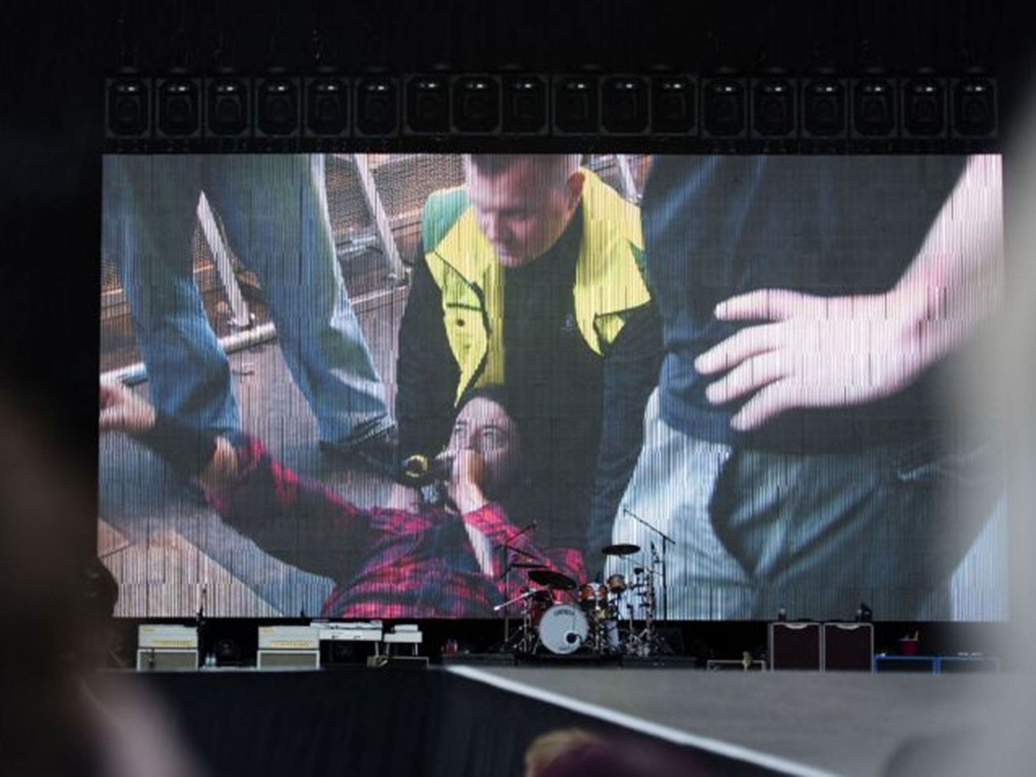 A screen shows singer of US band "Foo Fighters" Dave Grohl in the background of the empty stage during the band's concert att Nya Ullevi in Gothenburg, Sweden, on June 12, 2015. Grohl broke his leg while performing on stage in Gothenburg.