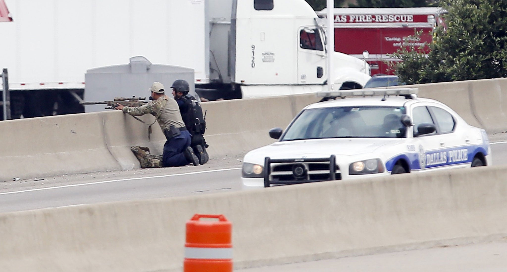 A sniper and a tactical officer take up positions on the shoulder of Interstate 45 during the stand off with a gunman (credit: Brandon Wade/ AP).