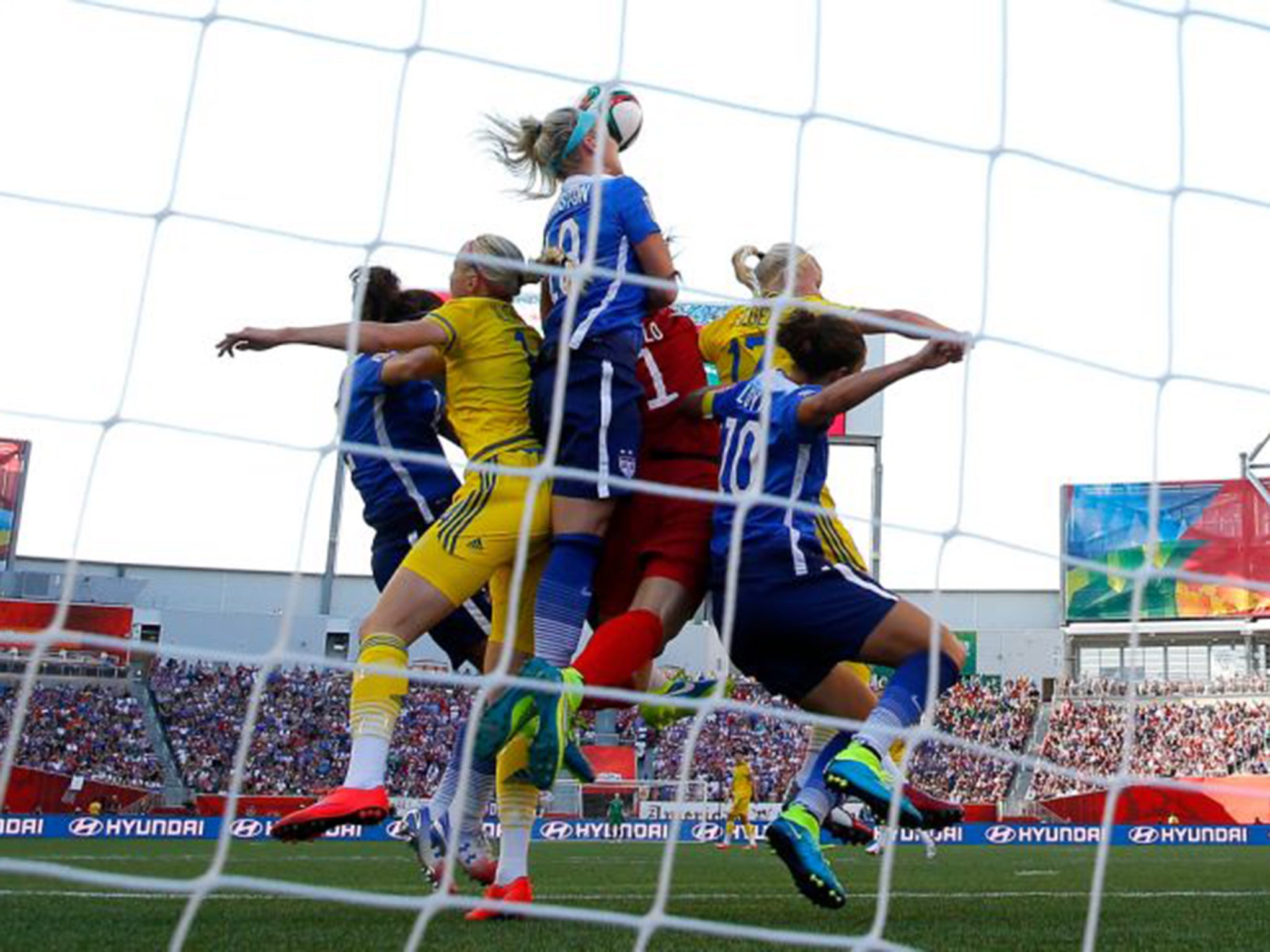 Staying on top: US Women’s keeper Hope Solo, in red, in the draw with Sweden on Friday