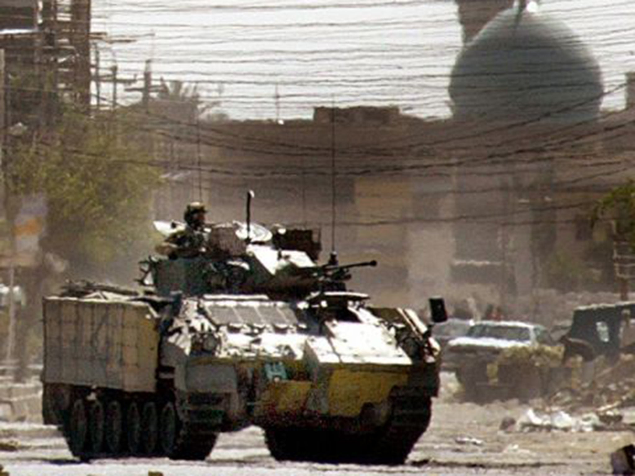 A British tank patrols in Basra, Iraq, in April 2004