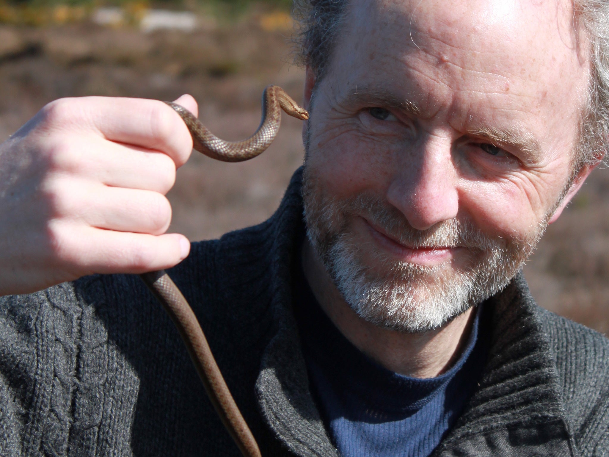 Charlie Elder with a smooth snake, one of the endangered species he encountered in his year of British wildlife watching