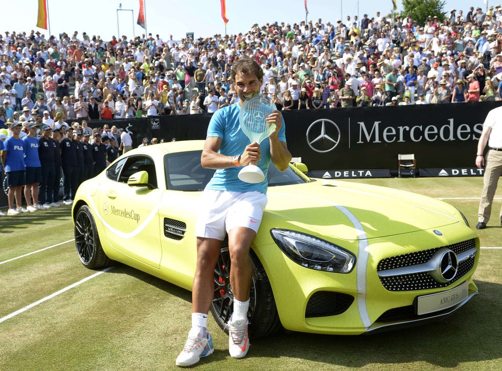 Rafa Nadal with the cup and car he won for clinching the Stuttgart grass-court tournament