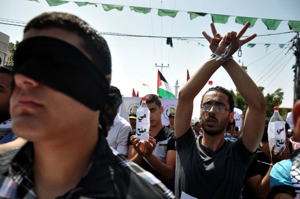 Protesters stage a silent protest for Palestinian prisoners on hunger strike in Israeli prisons