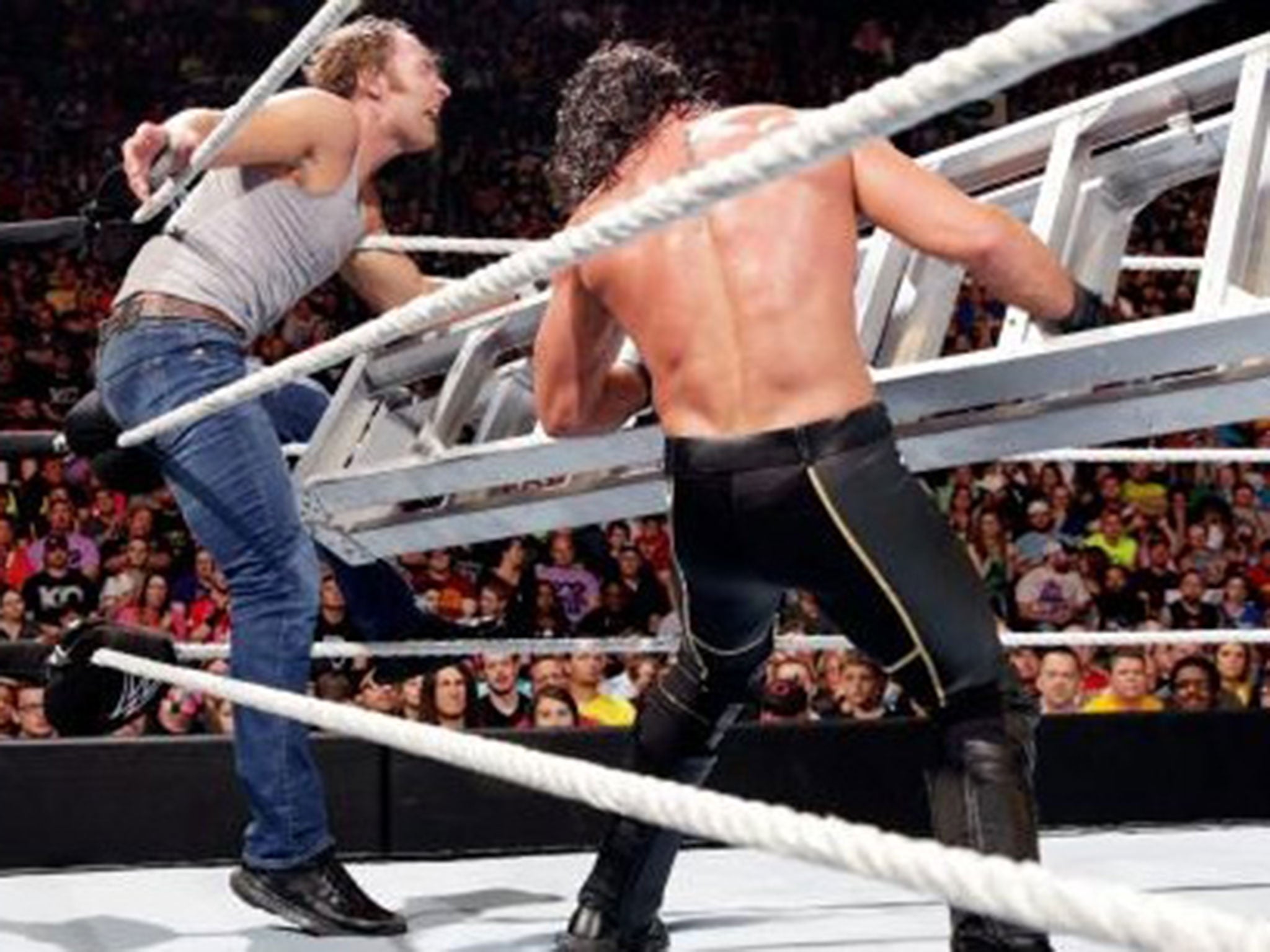 Seth Rollins strikes Dean Ambrose with the ladder