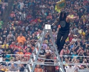 Bray Wyatt tips Roman Reigns off the ladder