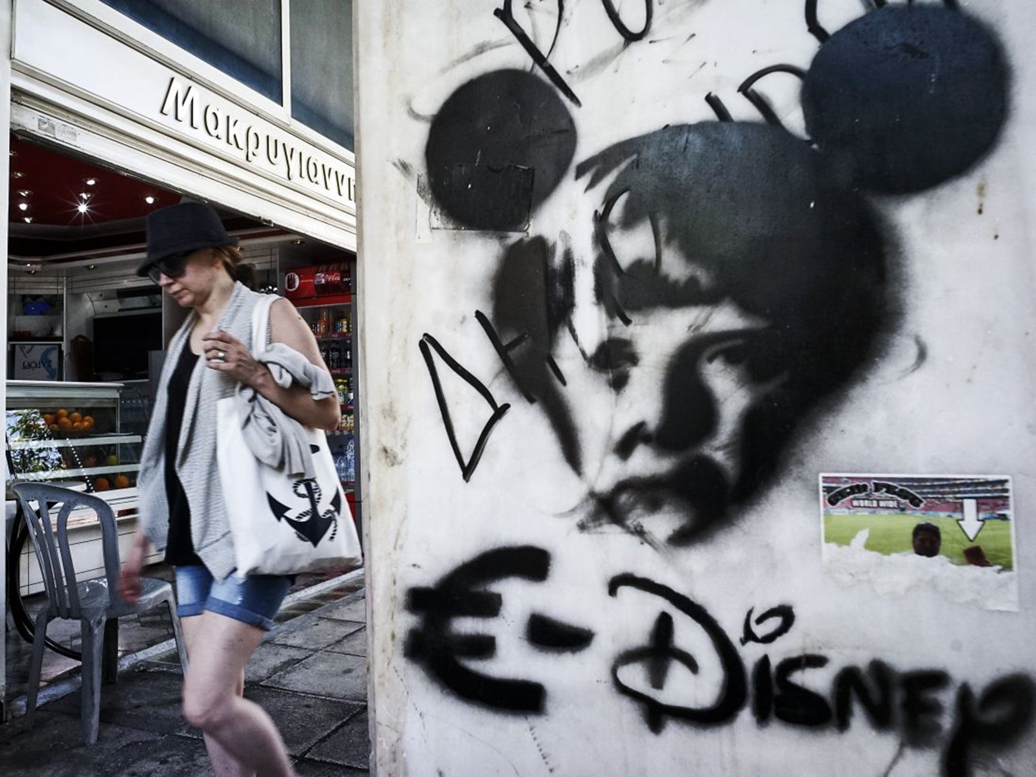 Graffiti in Athens takes a dim view of Angela Merkel and the euro; Greece is now back in recession (Getty)