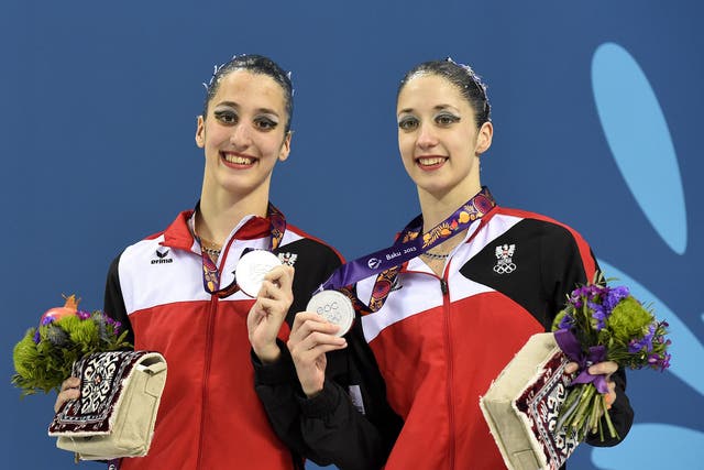 Austria's Anna-Maria Alexandri and Eirini-Marina Alexandri pose with their silver medals after the synchronized swimming duet free routine 