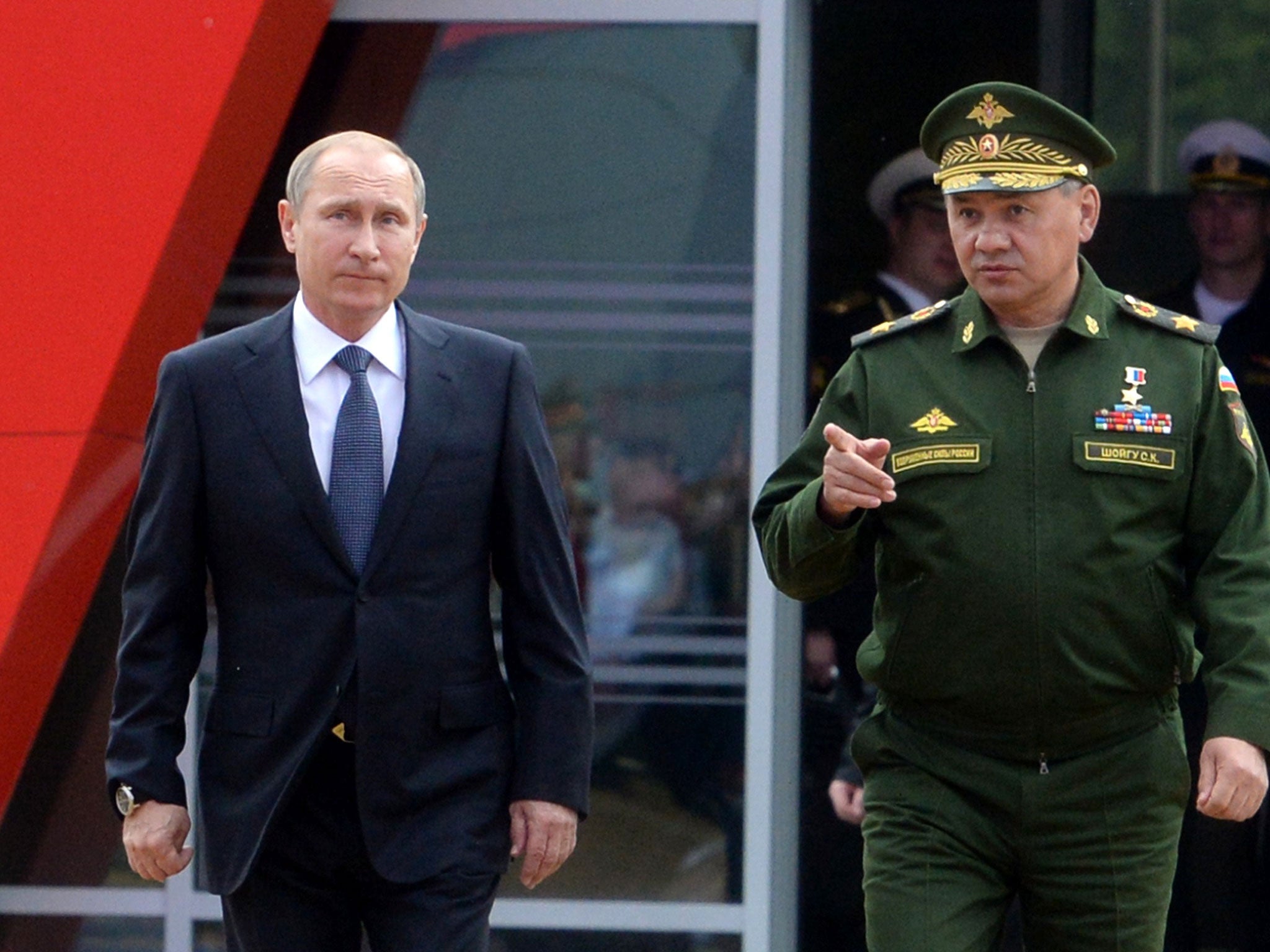 Vladimir Putin and Defence Minister Sergei Shoigu arrive for the opening of the Army-2015 international military forum in Kubinka, outside Moscow 