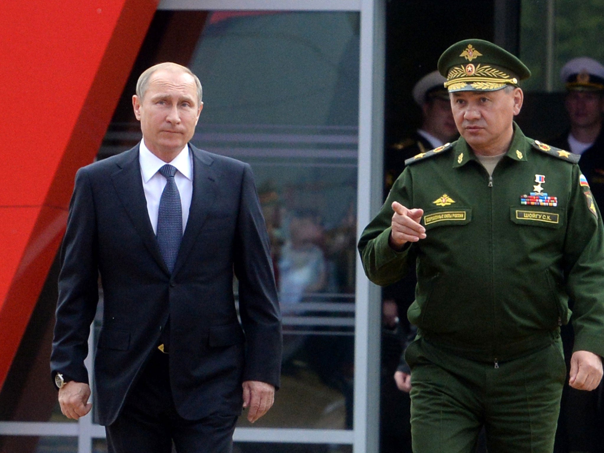 Vladimir Putin and Defence Minister Sergei Shoigu arrive for the opening of the Army-2015 international military forum in Kubinka, outside Moscow