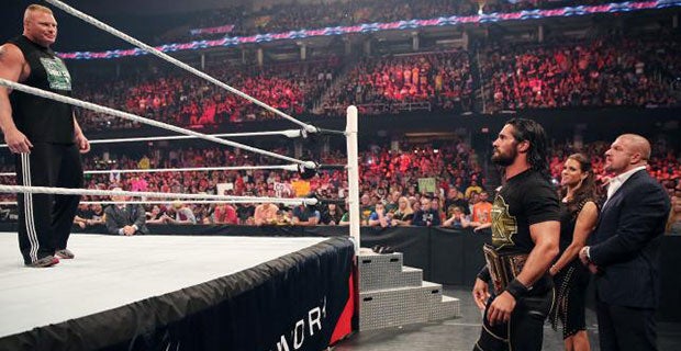 Rollins leaves the ring as Lesnar stands tall