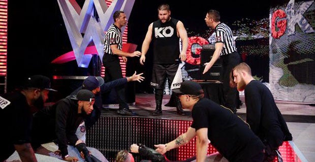 Kevin Owens stands over Machine Gun Kelly