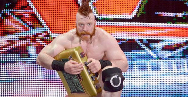 Sheamus cradles his Money in the Bank briefcase after defeat to Ambrose