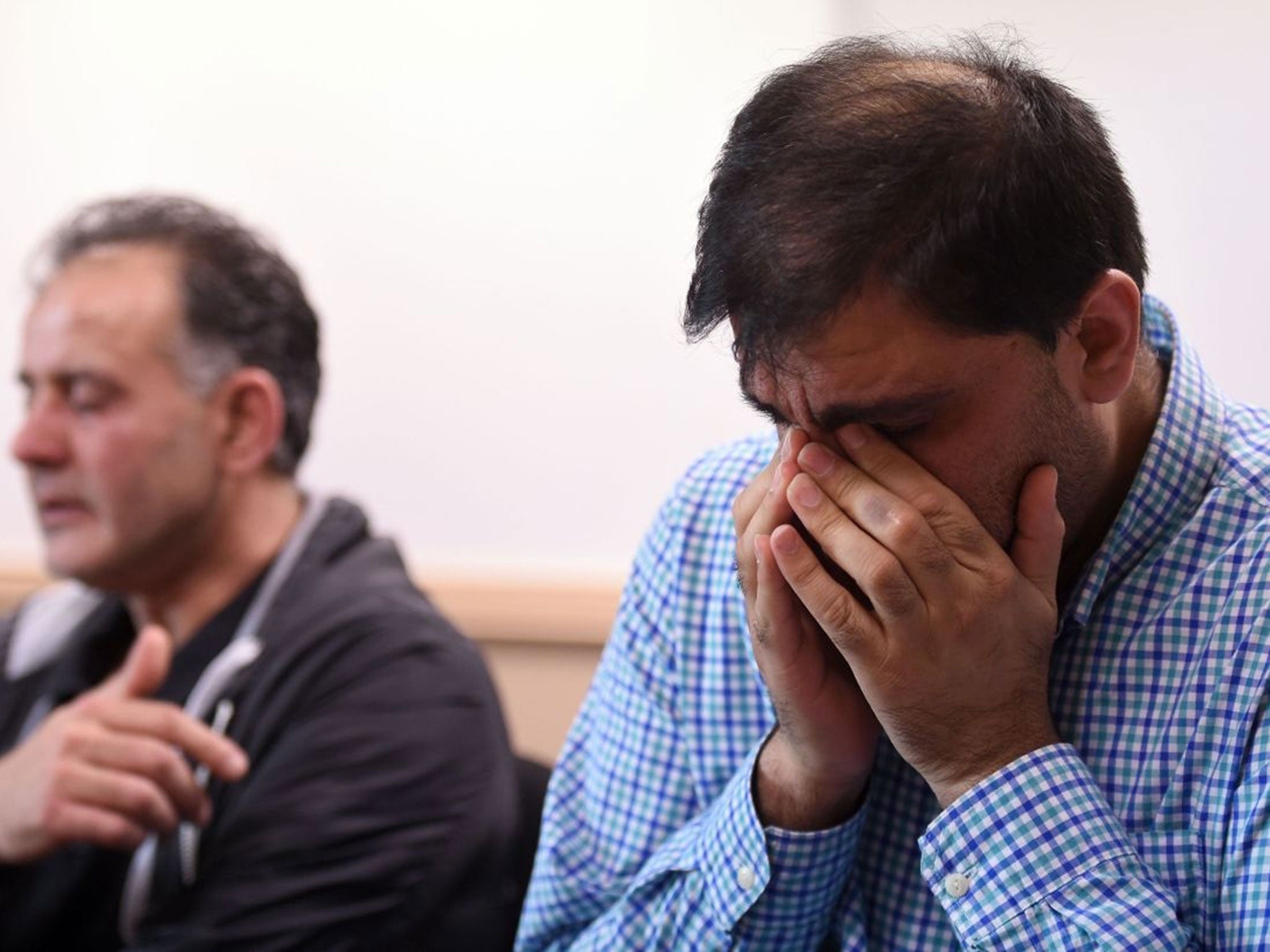 Akhtar Iqbal, husband of Sugra Dawood (L), and Mohammad Shoaib, husband of Khadija Dawood, react during a news conference to appeal for their return