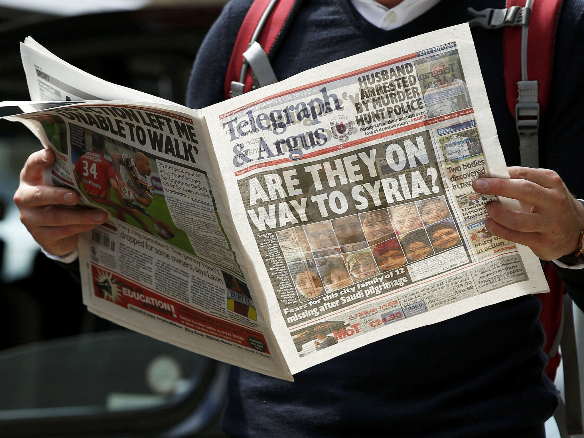 A man reads a local newspaper in Bradford