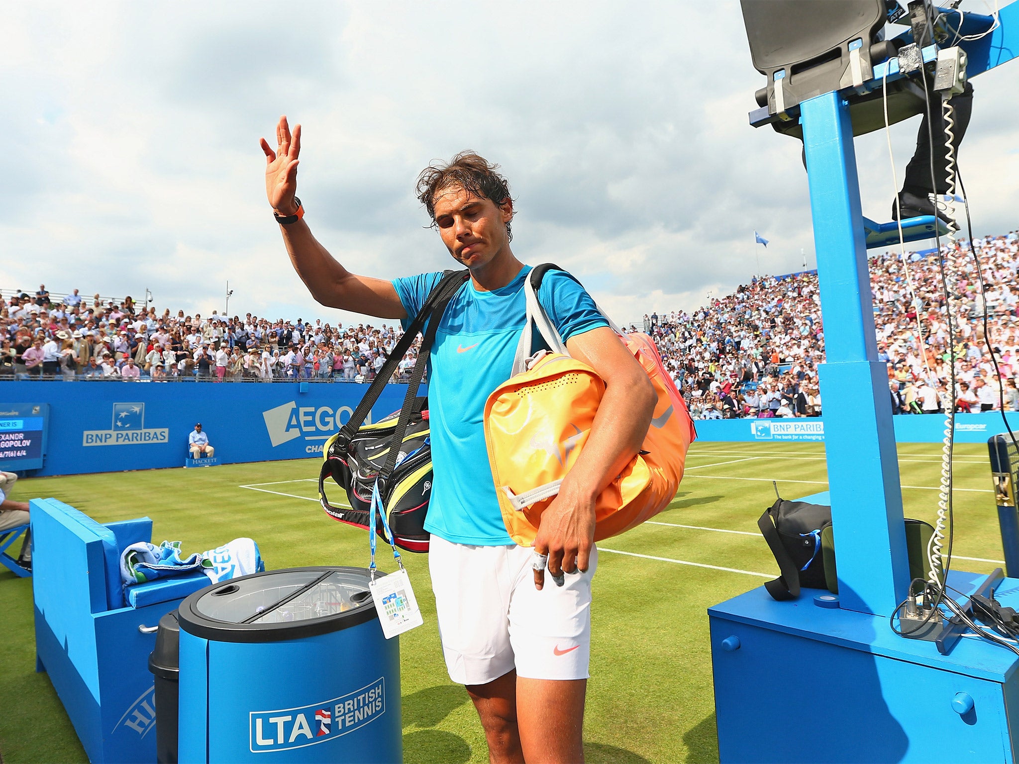 Rafael Nadal waves to the crowd at Queen’s Club after his first-round exit at the hands of unseeded Alexandr Dolgopolov