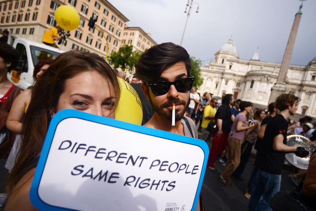 "How the world has flipped on its axis when right-wingers are asking to march in gay pride and gay activists are banning them" People take part in Rome's Pride Parade, June 13, 2015