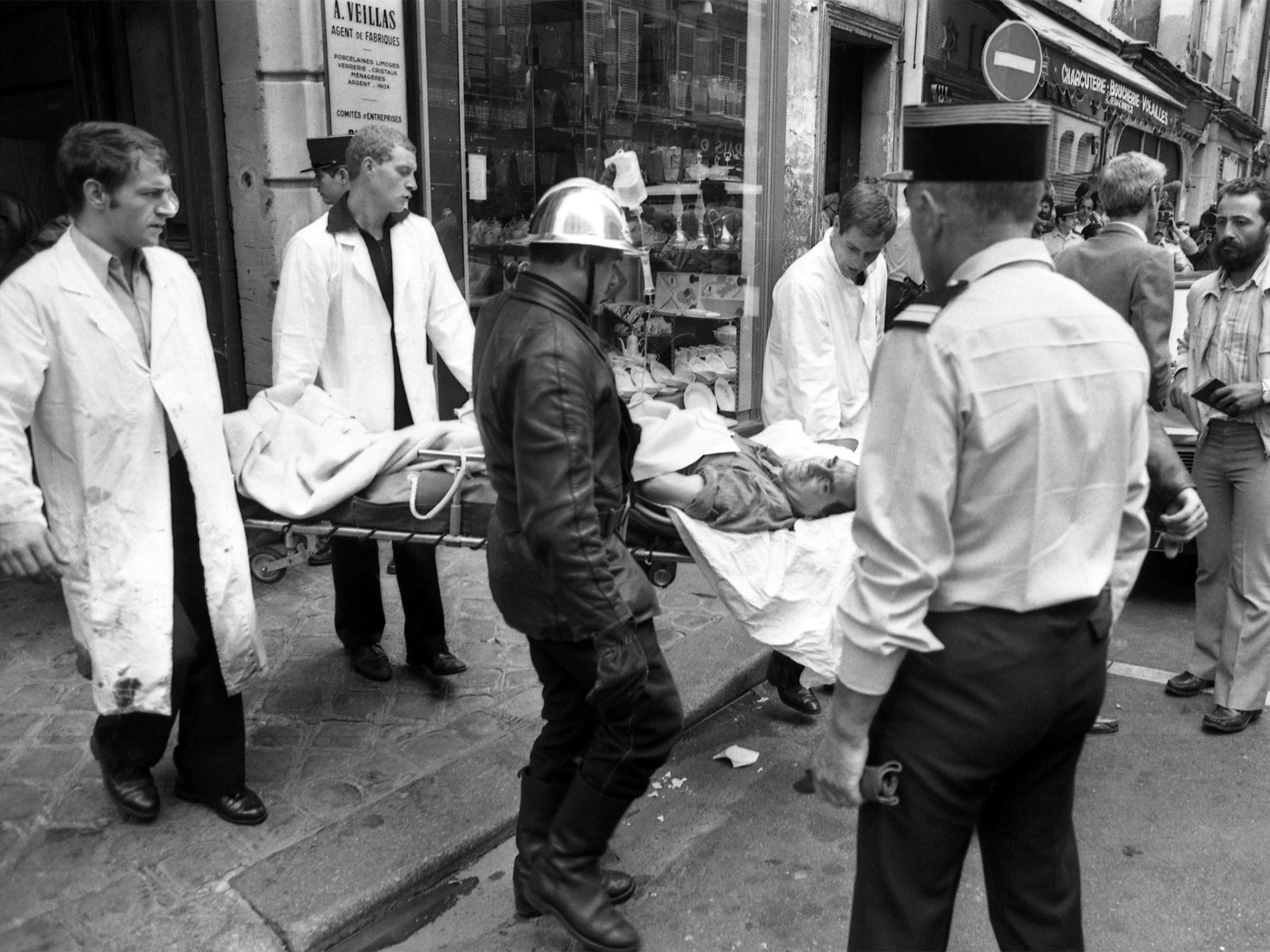 An injured man is carried away on a stretcher from the scene of a terror attack at Jewish restaurant Chez Jo Goldenberg, in Paris, August 1982